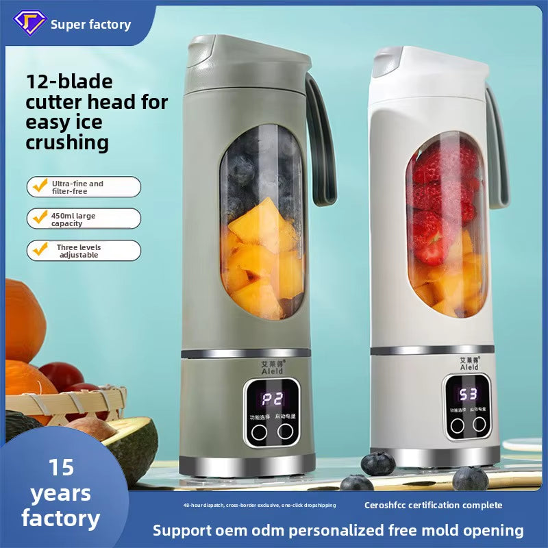 Portable Mini Electric Blender in white and green with fresh fruits inside for making smoothies.