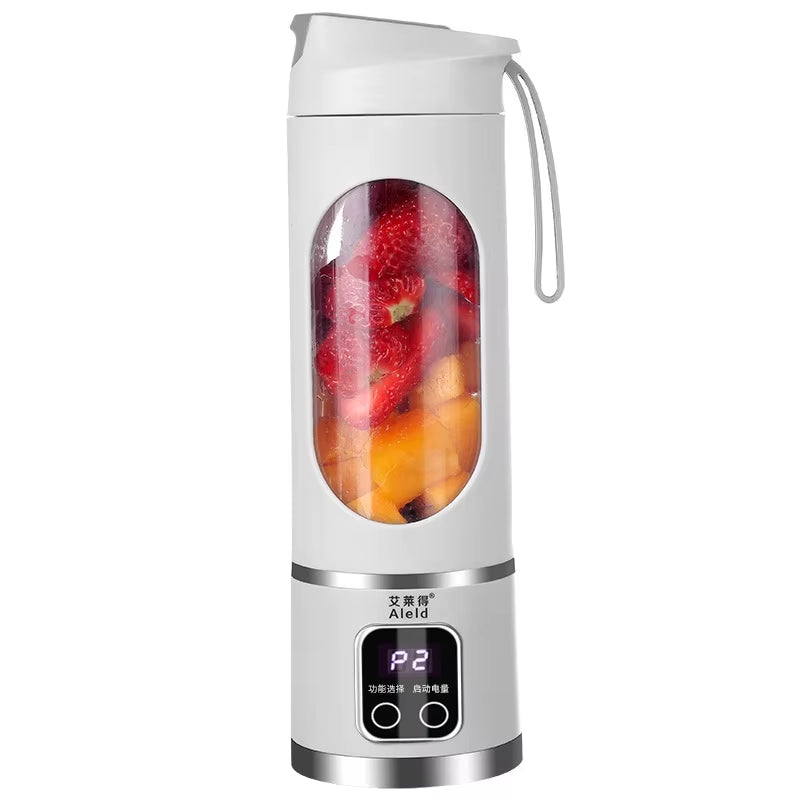 Portable Mini Electric Blender in white and green with fresh fruits inside for making smoothies.