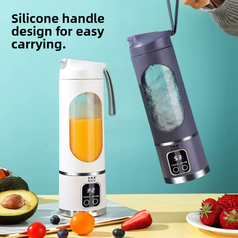 Portable Mini Electric Blender in white and green with fresh fruits inside for making smoothies.